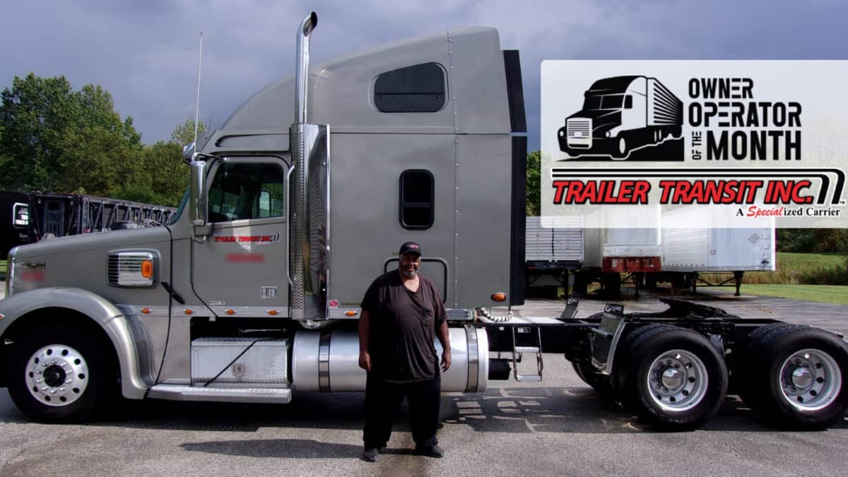Trailer Transit Inc. | A man stands beside a large gray semi-truck. A banner in the image reads "Owner Operator of the Month - Trailer Transit Inc." with a truck graphic. Trees and other trucks are in the background.