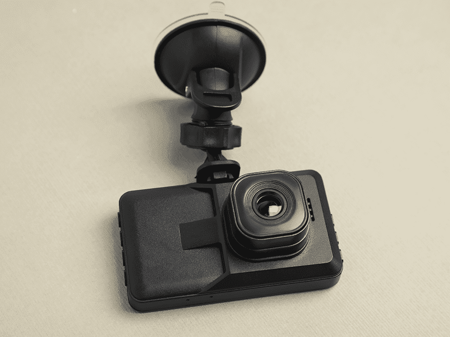 Trailer Transit Inc. | A black dashboard camera with a suction mount, designed for vehicle use, is shown against a plain background—ideal for owner operators and transport companies.
