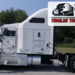 Trailer Transit Inc. | A man stands next to a white semi-truck with a forested background. An "Owner Operator of the Month" banner from Trailer Transit Inc. is prominently displayed in the top right corner.