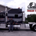 Trailer Transit Inc. | A man stands beside a large tractor-trailer truck in front of a gray building. The image features a logo indicating "Owner Operator of the Month" for Trailer Transit Inc.