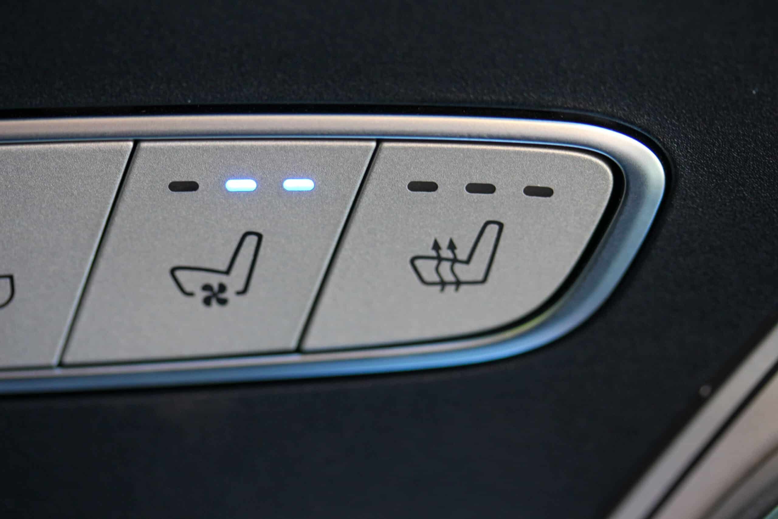 Trailer Transit Inc. | Close-up of car seat control buttons for seat ventilation.