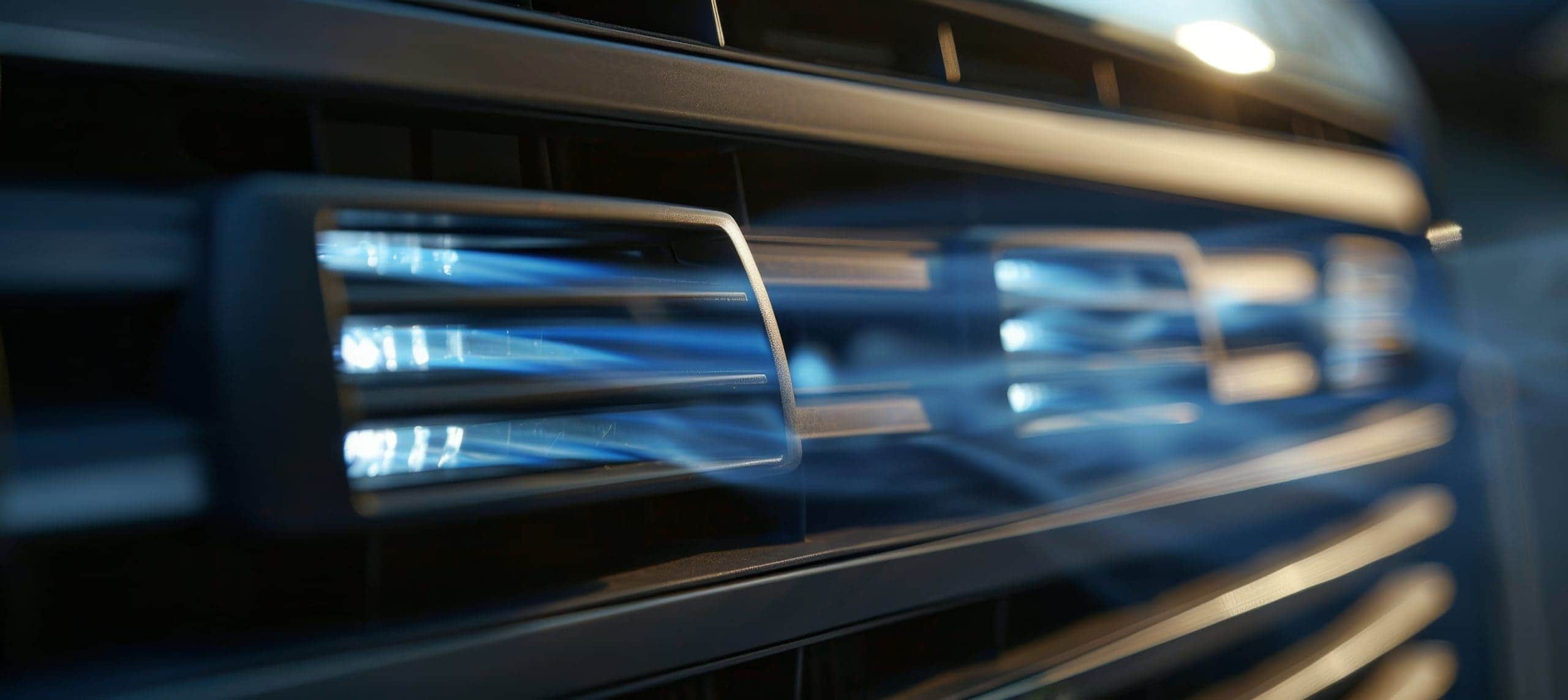 Trailer Transit Inc. | Close-up of a vehicle's AC vents blowing cold blue illustrated air.