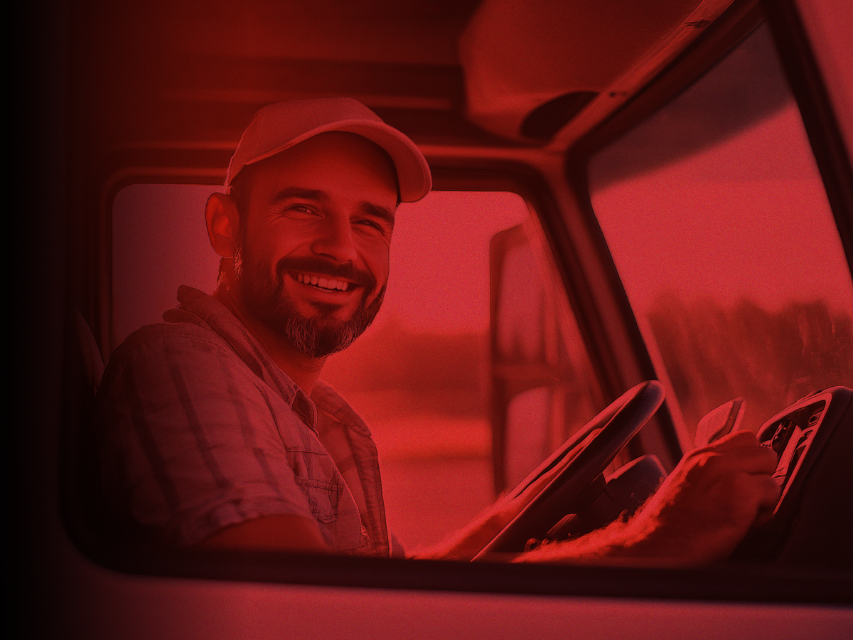 Trailer Transit Inc. | A smiling owner operator sits in the driver's seat of his truck.