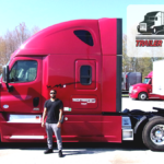 Trailer Transit Inc. | Owner Operator of the month, Demontre, stands in front of his red semi truck.